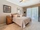 Serene primary bedroom featuring plush carpeting, a large window view, and neutral decor for relaxation at 25950 Risen Star Dr, Wesley Chapel, FL 33544