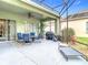 Spacious screened patio with dining and lounge areas, perfect for outdoor entertaining at 25950 Risen Star Dr, Wesley Chapel, FL 33544