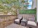 Balcony with outdoor seating, a small table, and a view of lush greenery and a large tree at 3106 Bayshore Oaks Dr, Tampa, FL 33611