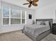 Cozy bedroom with a large window providing natural light, plush carpet, and neutral tones that promote relaxation at 3106 Bayshore Oaks Dr, Tampa, FL 33611