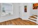 Versatile bonus room with laminate wood floors, large window, and a small staircase at 3106 Bayshore Oaks Dr, Tampa, FL 33611