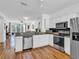 Modern kitchen featuring stainless steel appliances, white cabinetry, and granite countertops at 3106 Bayshore Oaks Dr, Tampa, FL 33611