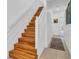 Wooden staircase with white trim and wainscoting, leading to the upper levels of the house at 3106 Bayshore Oaks Dr, Tampa, FL 33611