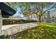 Backyard with a basketball court, lush greenery, and mature trees at 3115 W Fair Oaks Ave, Tampa, FL 33611
