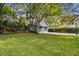 Lush backyard with a detached garage and an asphalt basketball court at 3115 W Fair Oaks Ave, Tampa, FL 33611