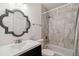 Bathroom features a shower-tub combo with gray tile and a large decorative mirror at 3115 W Fair Oaks Ave, Tampa, FL 33611