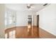 A spacious bedroom featuring a ceiling fan, window, and hardwood floors throughout at 3115 W Fair Oaks Ave, Tampa, FL 33611