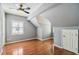 Bedroom features a ceiling fan, gray walls, hardwood floors, and a window at 3115 W Fair Oaks Ave, Tampa, FL 33611