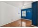 Cozy bedroom with hardwood floors, blue accent wall, and a bright window at 3115 W Fair Oaks Ave, Tampa, FL 33611