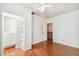Bright bedroom featuring hardwood floors, closet with built-in shelving, and neutral walls at 3115 W Fair Oaks Ave, Tampa, FL 33611