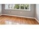 A well-lit bedroom with hardwood floors and a large window offering natural light at 3115 W Fair Oaks Ave, Tampa, FL 33611