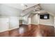 Loft-style bonus room with hardwood floors, ceiling fan, and wall-mounted TV at 3115 W Fair Oaks Ave, Tampa, FL 33611