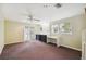 Spacious bonus room with carpet, natural light from windows, and direct access to the outside at 3115 W Fair Oaks Ave, Tampa, FL 33611