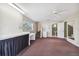 Large bonus room with mini-fridge and workspace in the basement, with a bathroom in the corner at 3115 W Fair Oaks Ave, Tampa, FL 33611