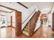 Elegant foyer featuring a staircase, wood trim, hardwood floors, and views into other living spaces at 3115 W Fair Oaks Ave, Tampa, FL 33611