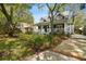 Beautifully landscaped front yard with lush greenery and a charming two-story home at 3115 W Fair Oaks Ave, Tampa, FL 33611