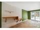 Garage interior with pegboard wall, work bench, green accent wall, and white doors at 3115 W Fair Oaks Ave, Tampa, FL 33611