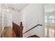 Upstairs hallway featuring hardwood floors, white walls, and an open doorway to a room with a bay window at 3115 W Fair Oaks Ave, Tampa, FL 33611