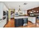 Gourmet kitchen boasts a large center island and stainless steel appliances and access to other living areas at 3115 W Fair Oaks Ave, Tampa, FL 33611
