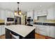 Bright kitchen featuring custom cabinets, stainless appliances, and a large island with a beverage center at 3115 W Fair Oaks Ave, Tampa, FL 33611