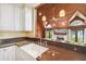 Charming kitchen with granite countertops, a farmhouse sink, wood-paneled ceiling and open to the living room at 3115 W Fair Oaks Ave, Tampa, FL 33611