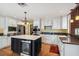 Bright kitchen featuring custom cabinets, stainless appliances, and a large island with a beverage center at 3115 W Fair Oaks Ave, Tampa, FL 33611