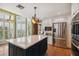 Bright kitchen featuring custom cabinets, stainless appliances, and a large island with a beverage center at 3115 W Fair Oaks Ave, Tampa, FL 33611