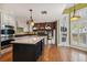 Gourmet kitchen with white cabinetry, a center island, and stainless steel appliances open to a bright dining area at 3115 W Fair Oaks Ave, Tampa, FL 33611