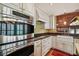 Kitchen featuring stainless appliances, custom cabinets, granite countertops, and farm sink at 3115 W Fair Oaks Ave, Tampa, FL 33611