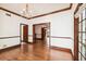 Open-concept living room with hardwood floors, decorative molding, and views into other areas of the home at 3115 W Fair Oaks Ave, Tampa, FL 33611