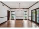 Bright living room with hardwood floors, white walls, and multiple windows with natural light at 3115 W Fair Oaks Ave, Tampa, FL 33611