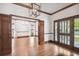 Open living room with hardwood floors, wooden trim and glass doors leading to the exterior at 3115 W Fair Oaks Ave, Tampa, FL 33611