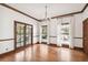 Bright and airy living room with wood floors, transom windows, and French doors leading to outdoor space at 3115 W Fair Oaks Ave, Tampa, FL 33611