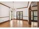 Bright living room with hardwood floors, white curtains, glass doors and wooden trim at 3115 W Fair Oaks Ave, Tampa, FL 33611
