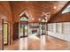 Vaulted wood ceiling over an open living area with stone fireplace and built in cabinets at 3115 W Fair Oaks Ave, Tampa, FL 33611