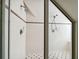 A tiled walk-in shower stall with updated fixtures and glass door at 3115 W Fair Oaks Ave, Tampa, FL 33611