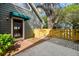 Side yard entrance with a brick walkway and charming wood fence at 3115 W Fair Oaks Ave, Tampa, FL 33611