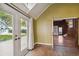 Brick floors and white trim highlight this sun room offering natural light and access to outdoor and indoor spaces at 3115 W Fair Oaks Ave, Tampa, FL 33611
