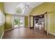 Sunroom featuring brick floors, high ceilings and access to an outdoor patio and a view to the main living area at 3115 W Fair Oaks Ave, Tampa, FL 33611