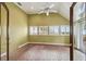 Bright sun room with red brick floors, shuttered windows, and a vaulted ceiling with ceiling fan at 3115 W Fair Oaks Ave, Tampa, FL 33611