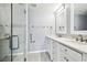 This bathroom features a glass shower and double vanity at 3248 Rock Valley Dr, Holiday, FL 34691