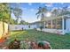 Spacious backyard with lush landscaping and a screened lanai, perfect for outdoor entertaining at 349 Shirley Ave, Belleair, FL 33756