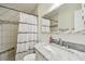 Well-lit bathroom featuring a marble vanity, tile shower, and contemporary fixtures at 349 Shirley Ave, Belleair, FL 33756