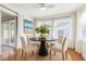 Cozy dining room featuring natural light, round table, and views of the backyard at 349 Shirley Ave, Belleair, FL 33756
