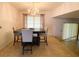 Elegant dining room features a modern chandelier, dark wood table with seating for four at 3712 Murray Dale Dr, Valrico, FL 33596