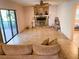 Bright living room with stone fireplace, tan tile floors, sliding glass doors, and an adjacent room at 3712 Murray Dale Dr, Valrico, FL 33596