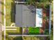 Birds eye view of a house with modern roof, fenced yard, and landscaped garden beds at 3907 Elkcam Se Blvd, St Petersburg, FL 33705