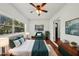 Bright bedroom features a ceiling fan, hardwood floors, and a large window for ample natural light at 3915 N Ola Ave, Tampa, FL 33603