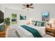 Comfortable bedroom featuring natural light from two windows, bedside tables, and stylish decor at 3915 N Ola Ave, Tampa, FL 33603