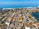 Stunning aerial view of a coastal neighborhood with the subject property marked by an arrow at 4550 Plaza Way, St Pete Beach, FL 33706